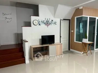 Modern living room with stylish decor and sleek staircase