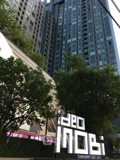Modern high-rise building with lush greenery at Ideo Mobi Sukhumvit East Gate.
