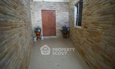 Charming entrance with stone walls and elegant wooden door