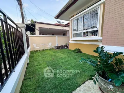 Charming garden area with fresh lawn and cozy seating, perfect for relaxation and outdoor enjoyment.
