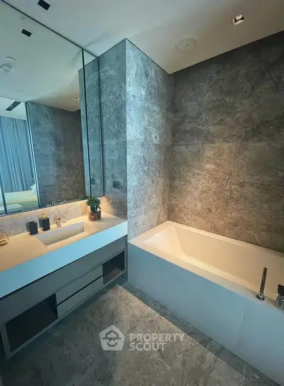 Luxurious modern bathroom with sleek marble walls and elegant bathtub