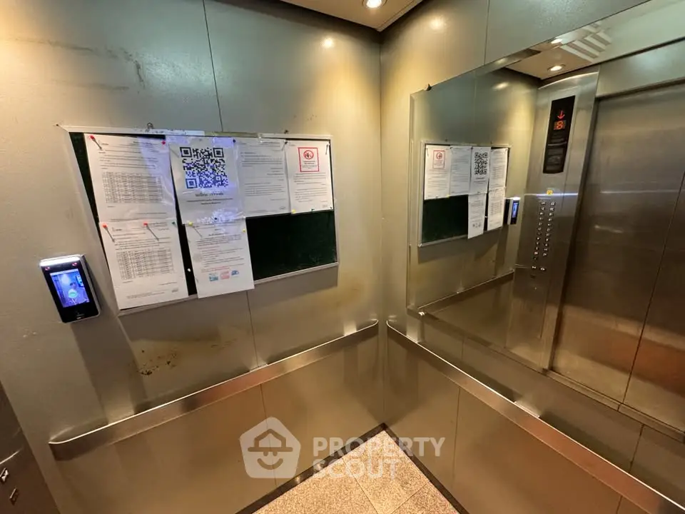 Modern elevator interior with notices and mirror in a residential building