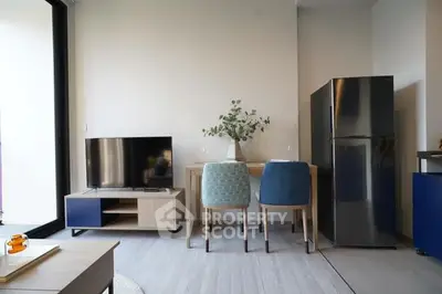 Modern minimalist living room with sleek furniture, large fridge, and ample natural light, perfect for urban living.