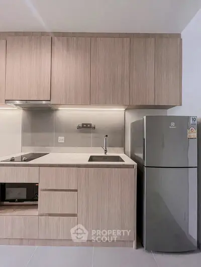 Modern kitchen with sleek cabinetry and stainless steel fridge