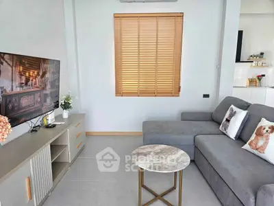 Modern living room with cozy gray sofa and stylish decor