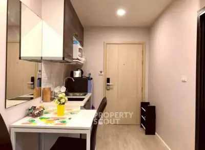 Cozy kitchen with modern appliances and dining area in compact apartment