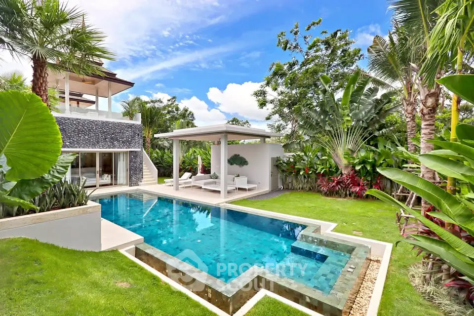 Luxurious villa with private pool and lush tropical garden, perfect for relaxation and entertaining.