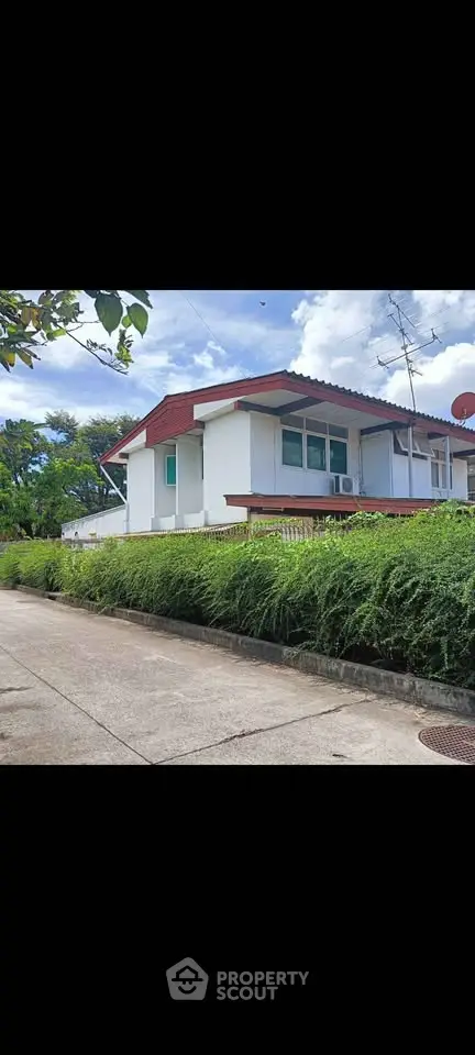 Charming single-story house with lush greenery and modern design in a serene neighborhood.