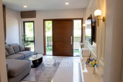 Modern living room with elegant decor and large windows offering natural light