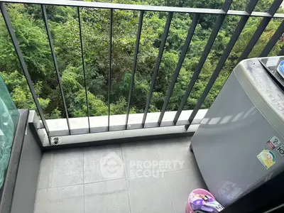 Charming balcony with lush green view and modern washing machine, perfect for relaxation and convenience.