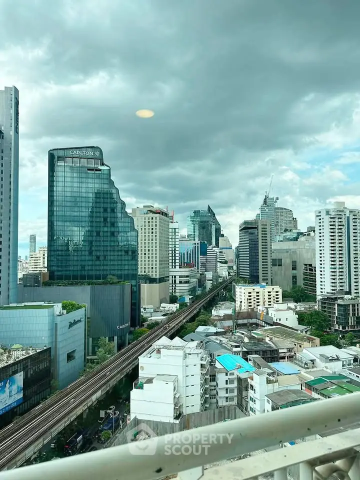 Stunning cityscape view from a high-rise balcony showcasing modern skyscrapers and urban skyline.