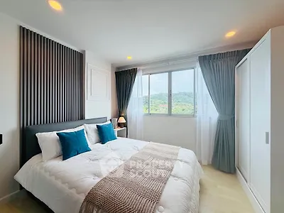 Spacious bedroom with scenic window view and modern decor