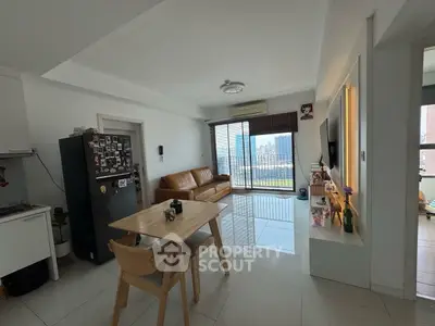 Modern living room with city view, stylish furniture, and open layout.