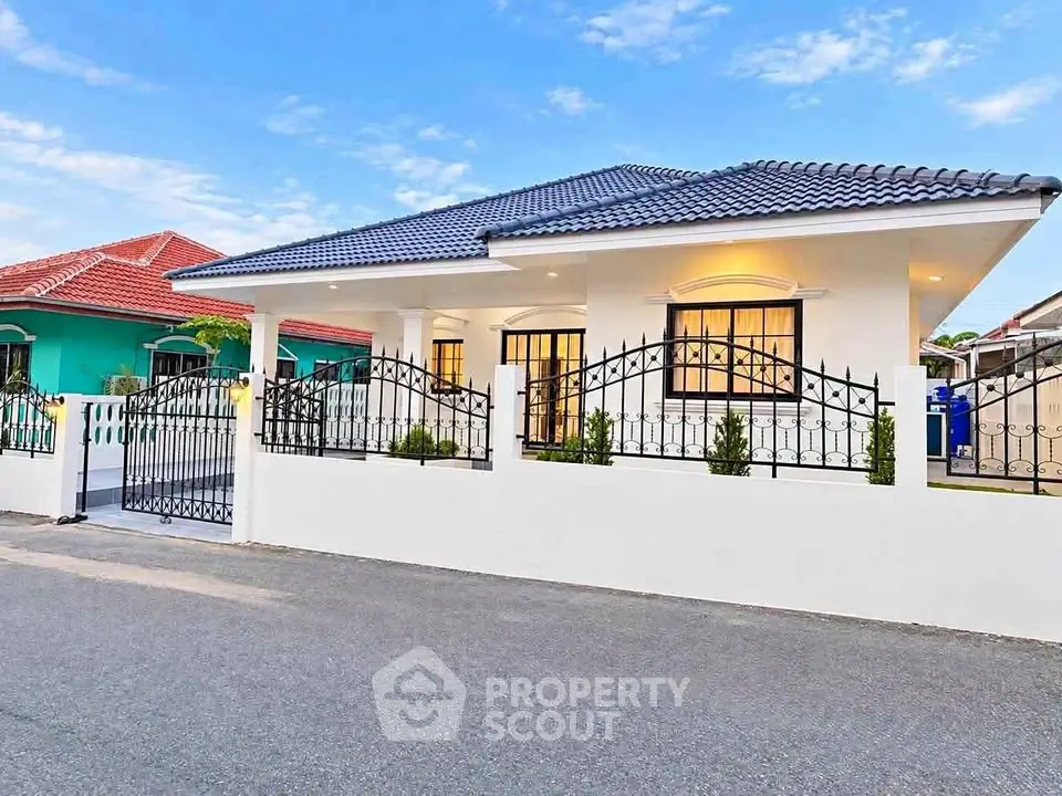 Charming single-story house with modern design and gated entrance in a serene neighborhood.