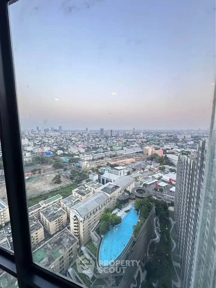 Stunning cityscape view from high-rise building with luxurious pool and skyline.