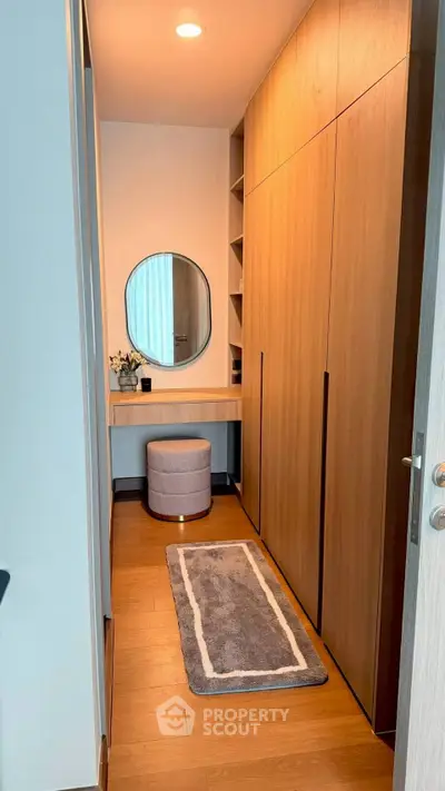 Stylish walk-in closet with wooden cabinetry and modern decor