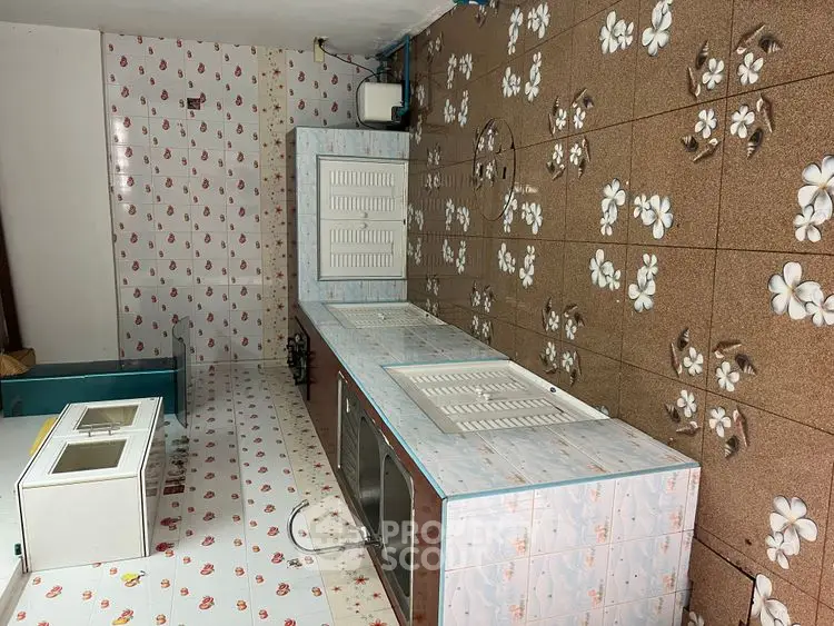 Unique kitchen with floral tile design and closed layout