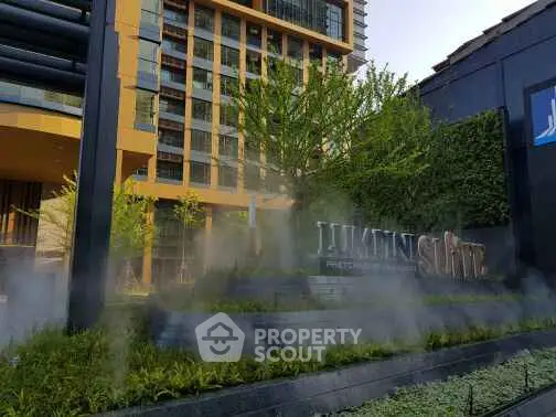 Modern building exterior with lush greenery and sleek design