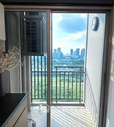 Stunning cityscape view from a modern apartment balcony with sleek railing and lush greenery.