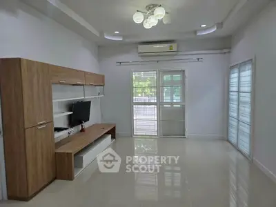 Spacious modern living room with sleek furniture and large windows for natural light.