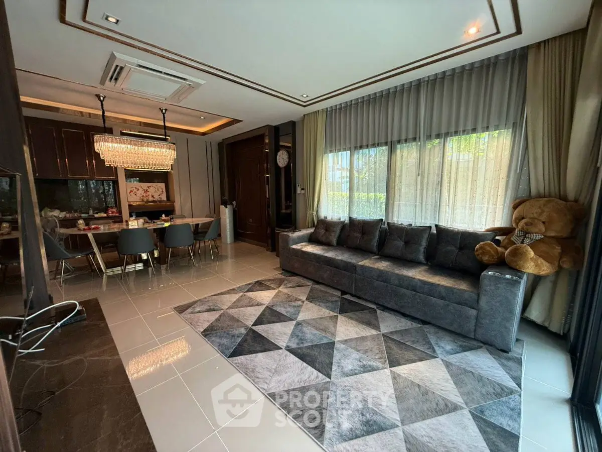 Luxurious living room with modern decor, plush sofa, and elegant dining area in open layout.