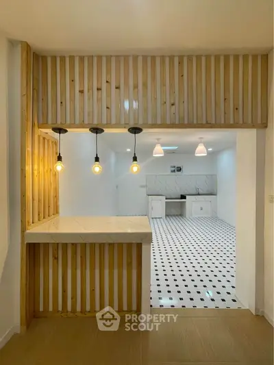 Modern kitchen with open layout and stylish lighting fixtures