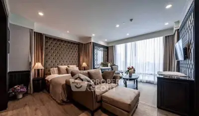 Luxurious living room with elegant decor and large windows offering natural light.