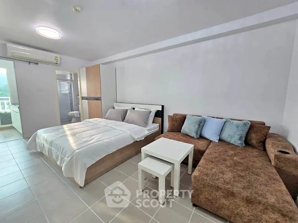 Modern studio apartment with cozy bed and stylish sofa in open layout