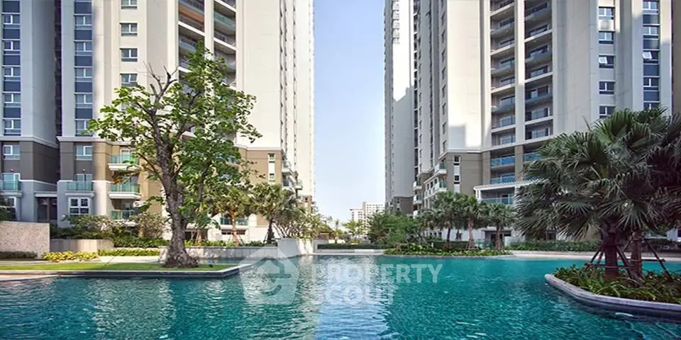 Luxurious residential complex with stunning pool and modern high-rise buildings.