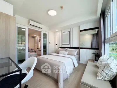 Modern bedroom with stylish decor and large windows offering natural light and scenic views.