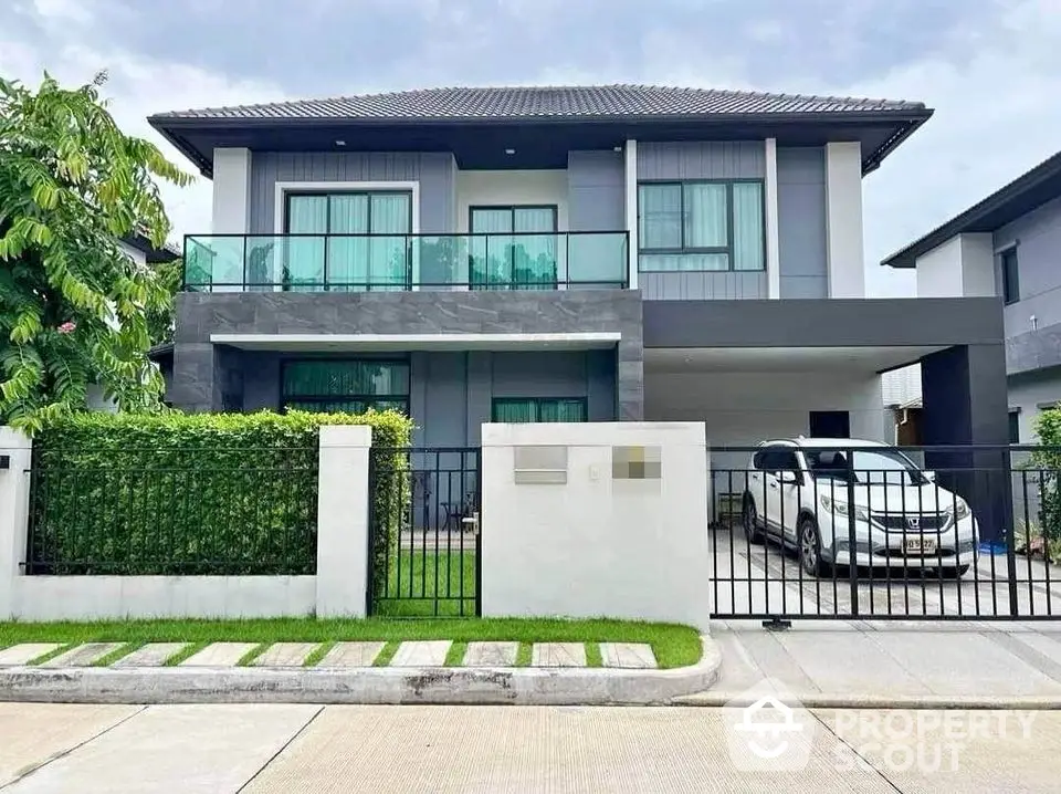 Modern two-story house with sleek design and spacious driveway