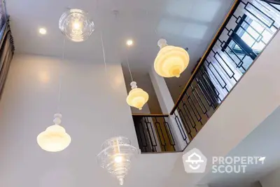 Modern interior with stylish pendant lights and elegant staircase design