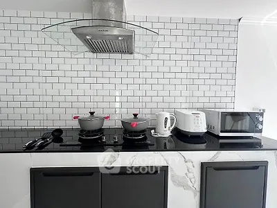 Modern kitchen with sleek appliances and stylish backsplash