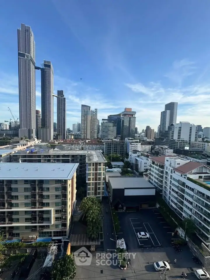 Stunning cityscape view showcasing modern skyscrapers and residential buildings under a clear blue sky.