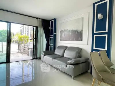 Modern living room with sleek gray sofa and elegant decor