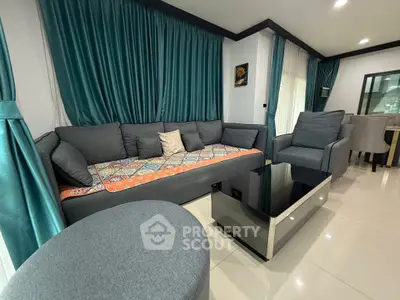 Modern living room with stylish gray furniture and vibrant teal curtains