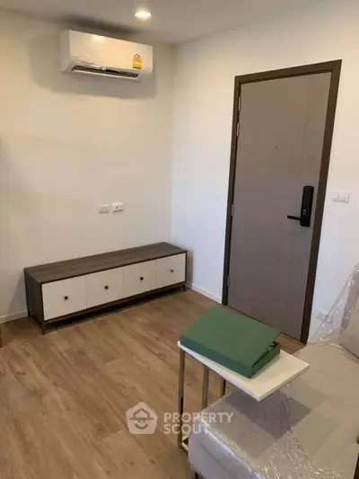 Modern living room with air conditioning and stylish furniture, perfect for comfortable living.