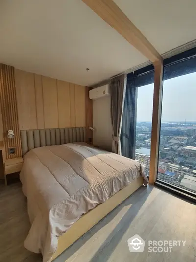 Spacious bedroom with panoramic city views through floor-to-ceiling windows, modern wooden wall paneling, and elegant interior design.