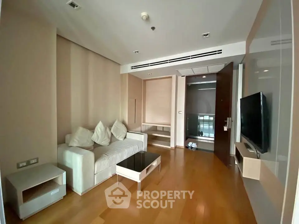 Modern living room with sleek furniture and wooden flooring