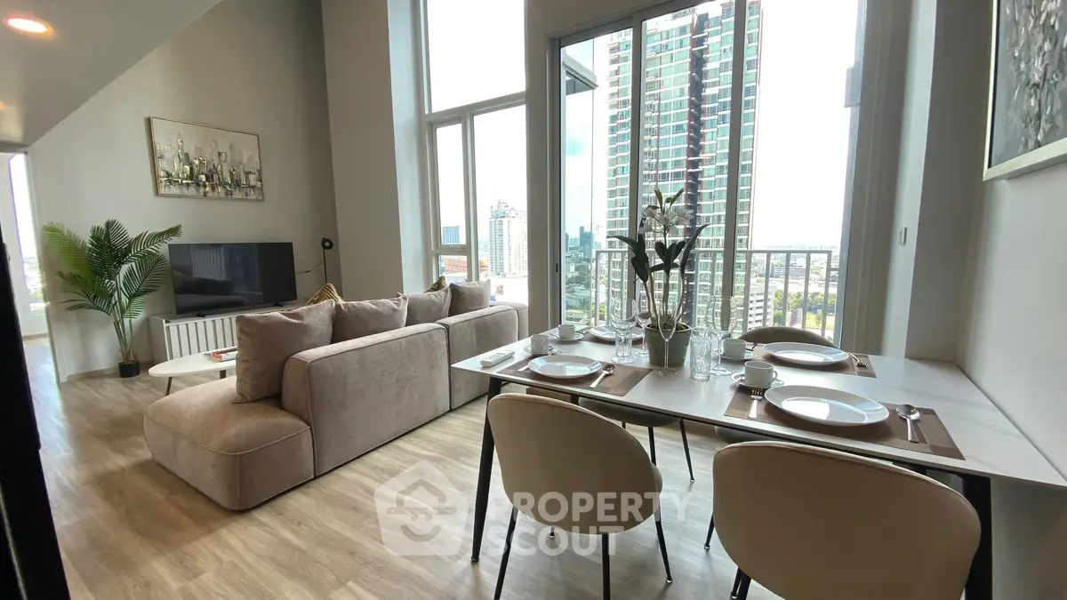 Modern living room with dining area and city view from balcony