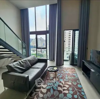 Luxurious modern living room with high ceilings and city view, featuring stylish furniture and elegant decor.