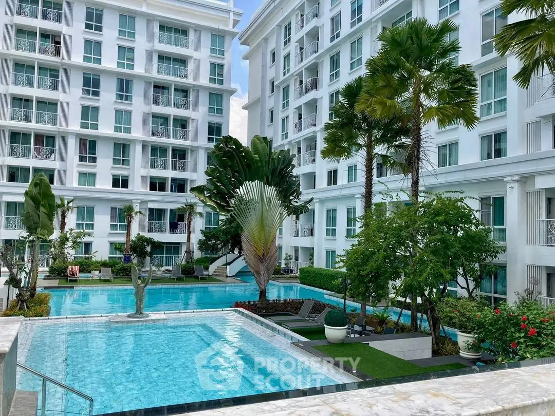 Luxurious residential complex with stunning pool and lush garden landscaping.