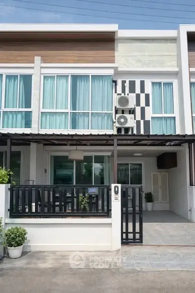 Modern townhouse exterior with stylish facade and gated entrance
