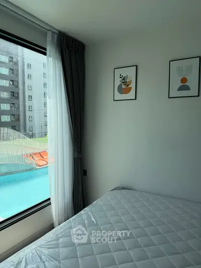 Modern bedroom with pool view and stylish decor in urban apartment