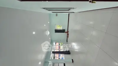 Spacious empty living room with large windows and tiled flooring