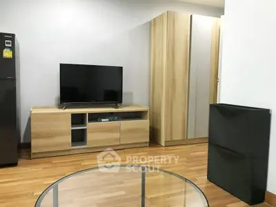 Modern living room with sleek wooden furniture and flat-screen TV