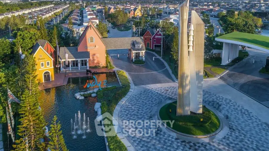 Stunning aerial view of modern residential complex with unique architecture and lush landscaping.