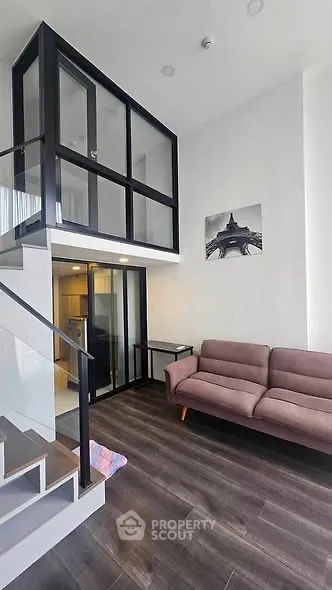 Modern loft-style living room with high ceilings and stylish decor