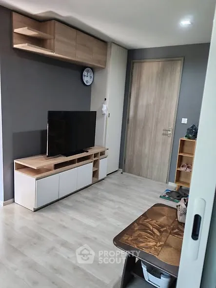 Modern living room with sleek TV stand and wooden flooring