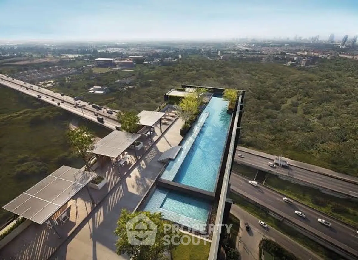 Stunning rooftop pool with panoramic city views and lush greenery